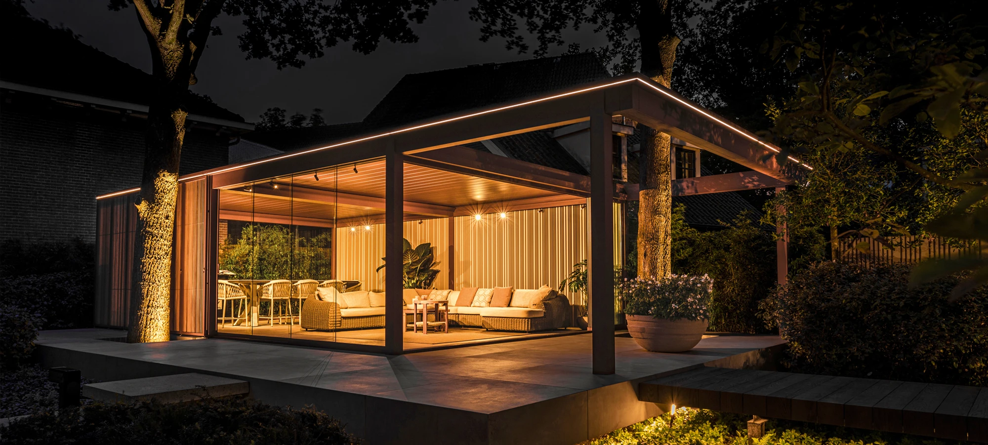 Renson pergola with integrated lighting at dusk